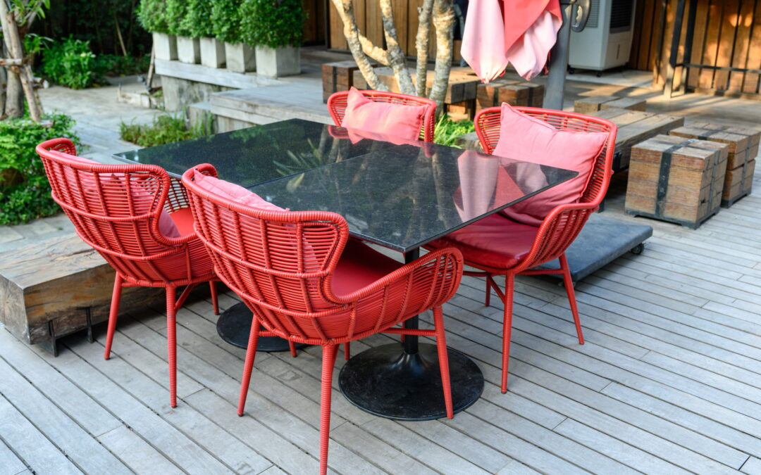 Marble dining table with red weave chairs with pillow on patio