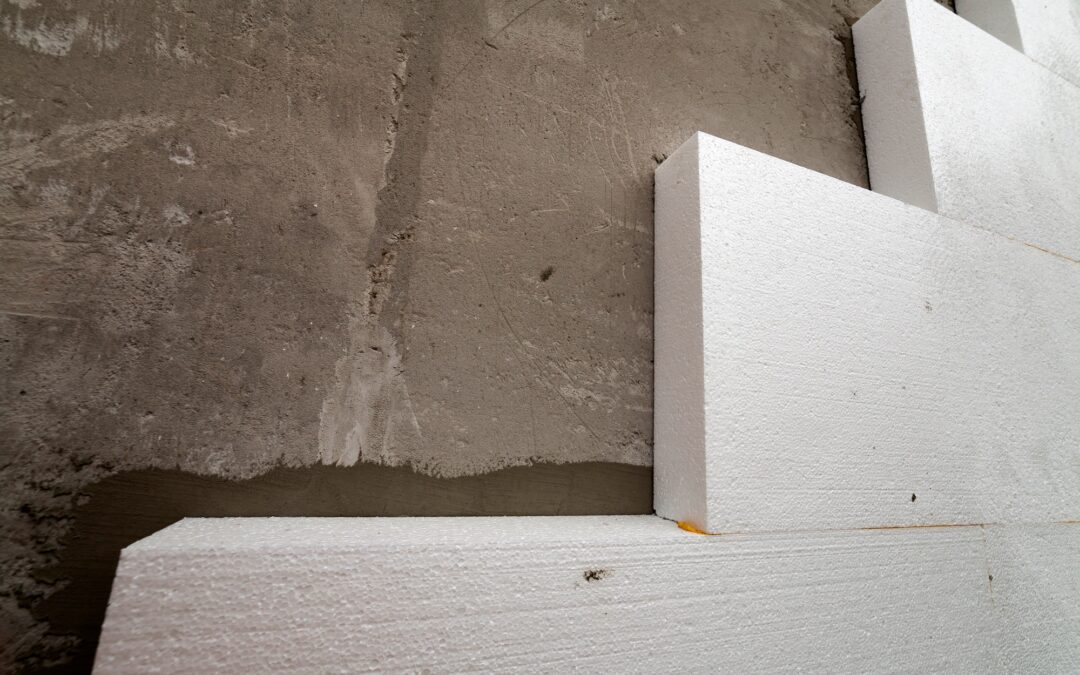 Close-up detail of plastered house wall with rigid styrofoam insulation.